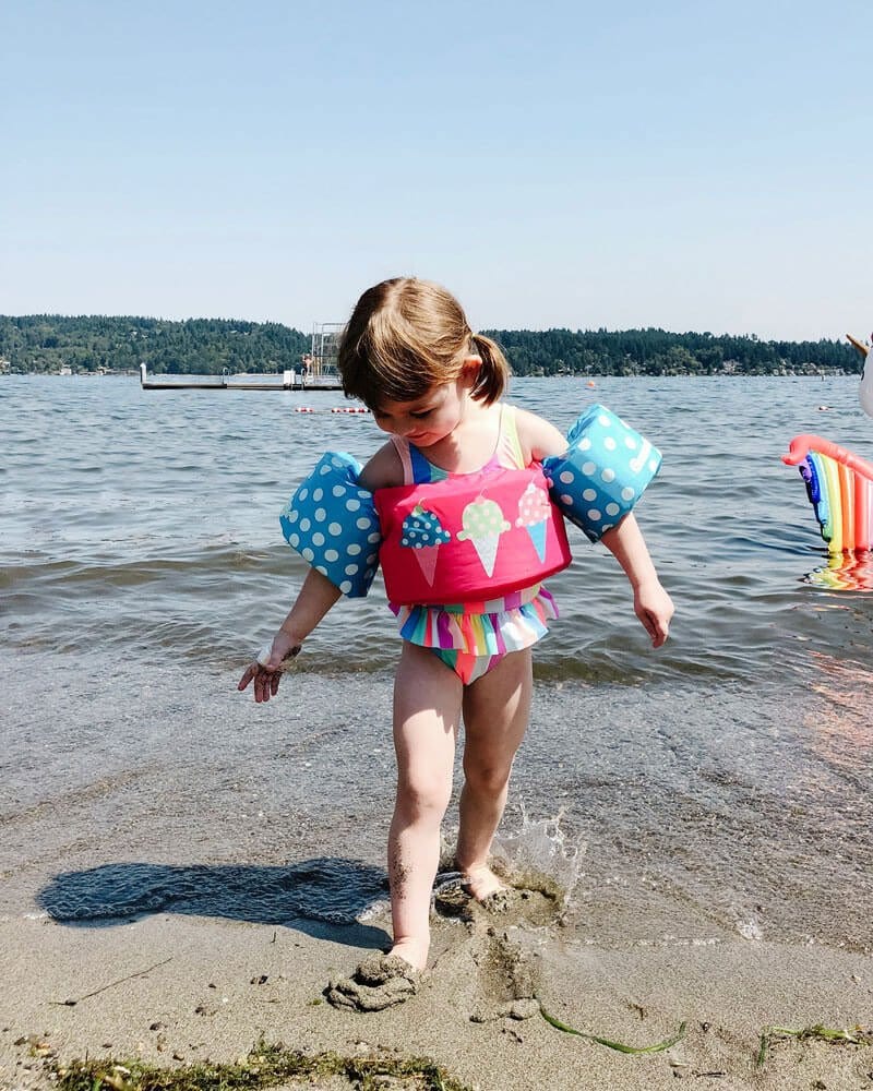 smiling girl walking in the sand at the beach