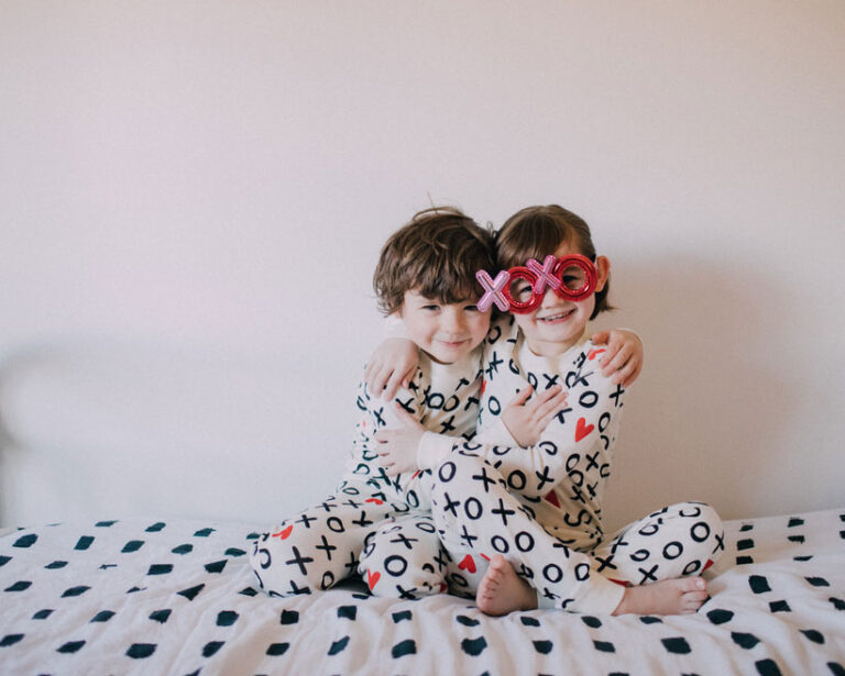 Two children wearing pajamas and hugging