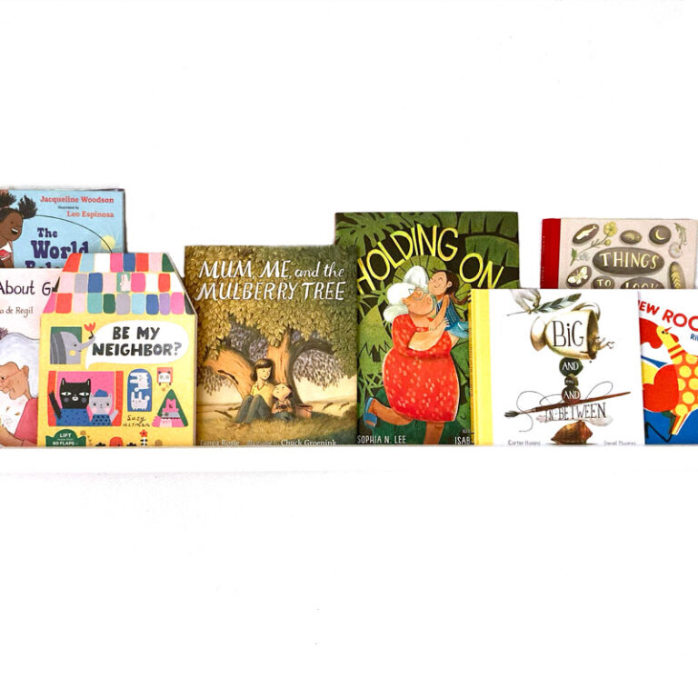 children's picture books on a white bookshelf and white background